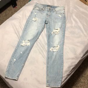 FASHION NOVA light wash denim distressed jeans.